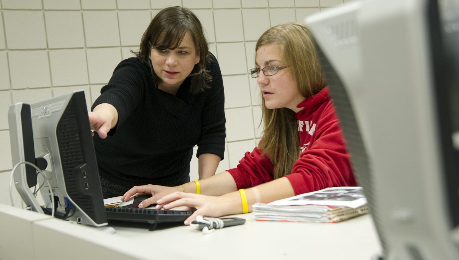 student & instructor at computer