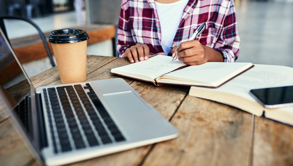 Cropped shot of an unrecognizable female student studying outside on campus