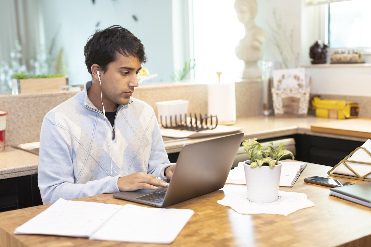 Student working on a laptop at home