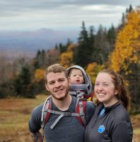 Photo of Robert Hickey in woods with woman and infant